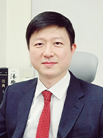 Headshot of Yongjeong Lee sitting in his office. 
